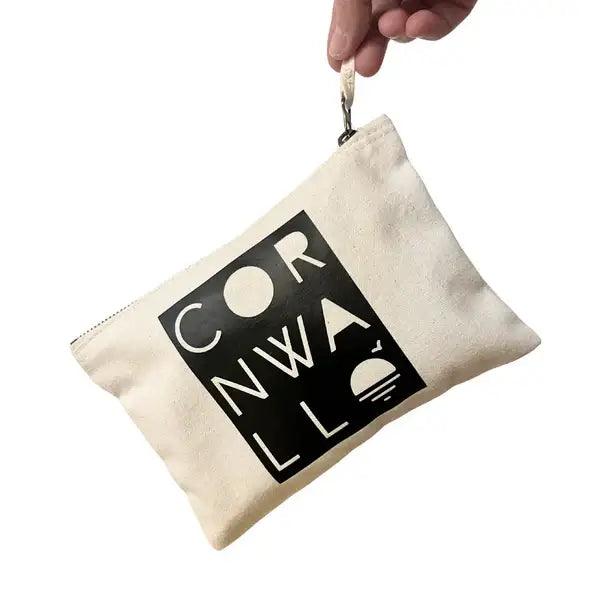  A stylish white cotton bag with zip showcasing a handprinted black Cornwall- themed design, ideal for storing your valuables