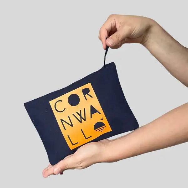 A stylish navy blue cotton bag with zip showcasing a handprinted yellow Cornwall- themed design, ideal for keeping your valuable safe