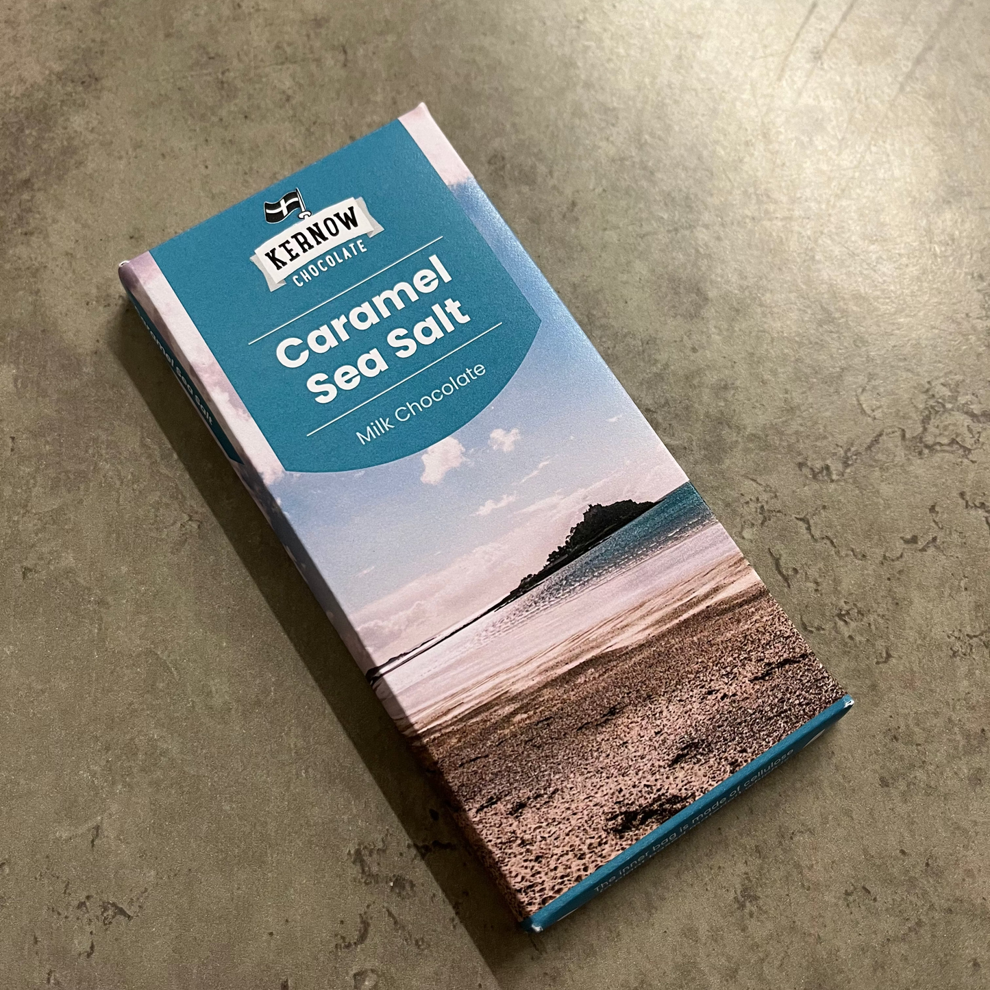 Chocolate bar packaging with a scenic design on a concrete surface
