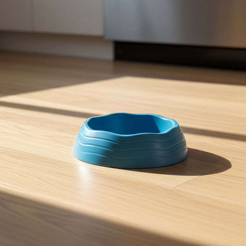 Blue recycled plastic bowl on a wooden floor background