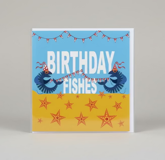 Birthday card with 'Birthday Fishes' design on a wooden surface