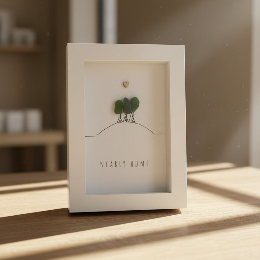 Decorative box with a small plant and card on a wooden surface