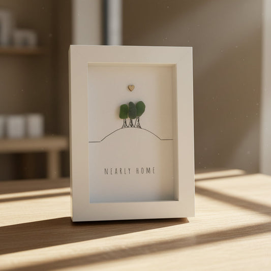 Decorative box with a small plant and card on a wooden surface