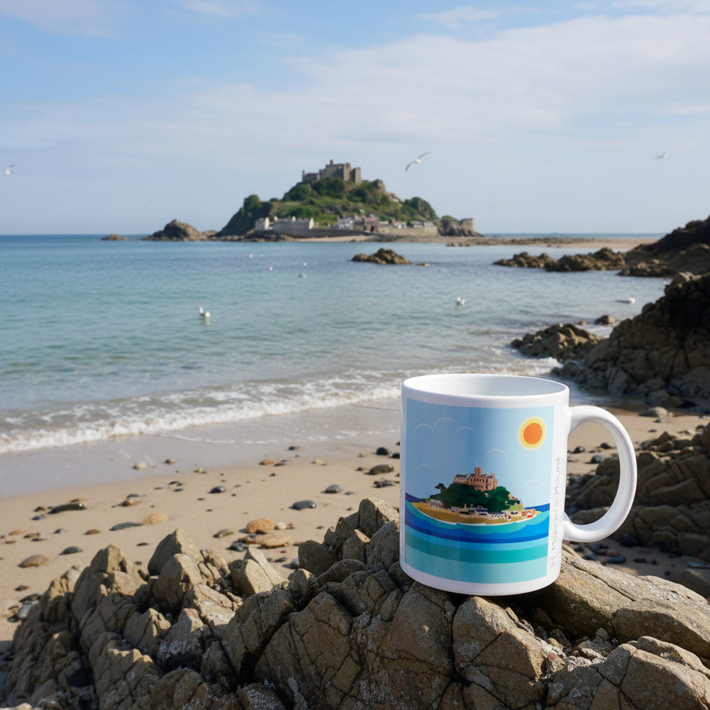 a mug with an image of st michaels mount on it set on a beach with st michaels mount in the background